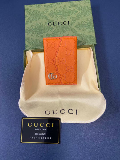 Chic Gucci wallet with sleek silhouette and embossed logo detail