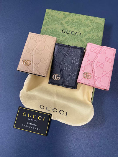 Elegant Gucci wallet open showing multiple compartments for cash and cards