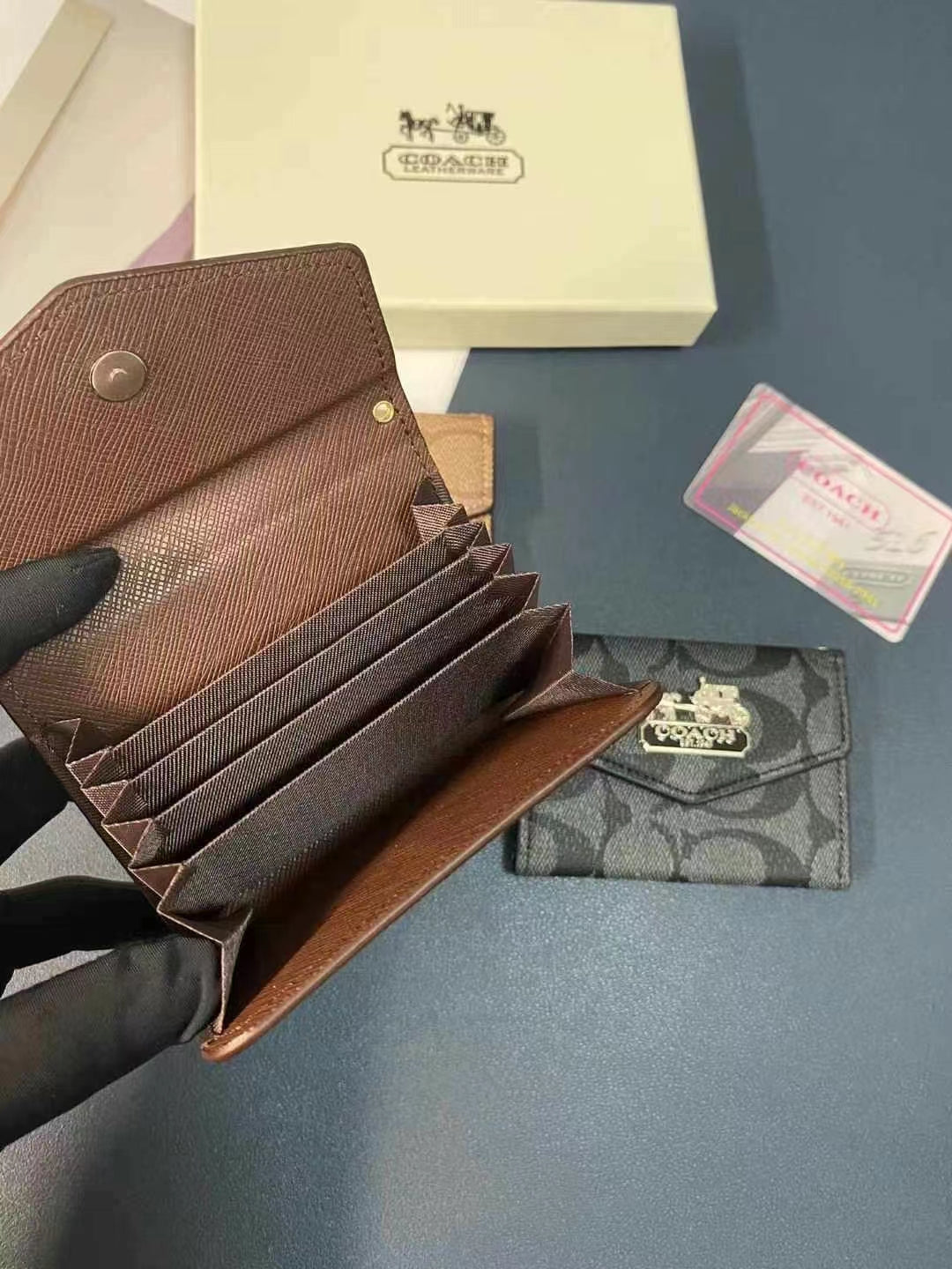 Close-up of the Coach Wallet and Card Holder Duo featuring the iconic Coach logo