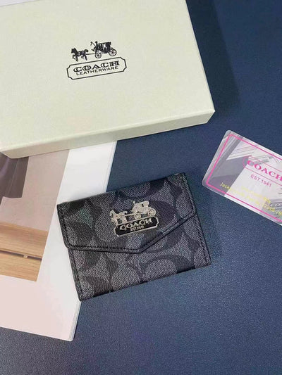Model holding the Coach Wallet and Card Holder Duo, showcasing its stylish design