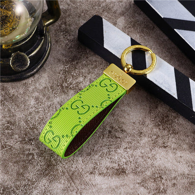 Gucci Keychain featuring the iconic logo and luxurious design, displayed against a neutral backdro