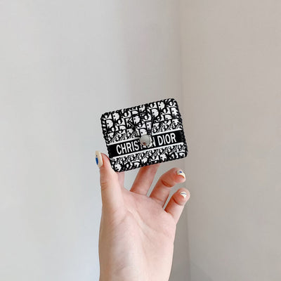 Hand holding the Dior Premier Chic AirPods Case, emphasizing its portable and lightweight design