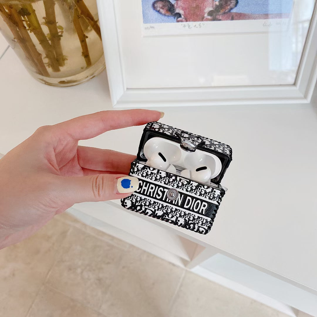 Hand holding the Dior Premier Chic AirPods Case, emphasizing its portable and lightweight design